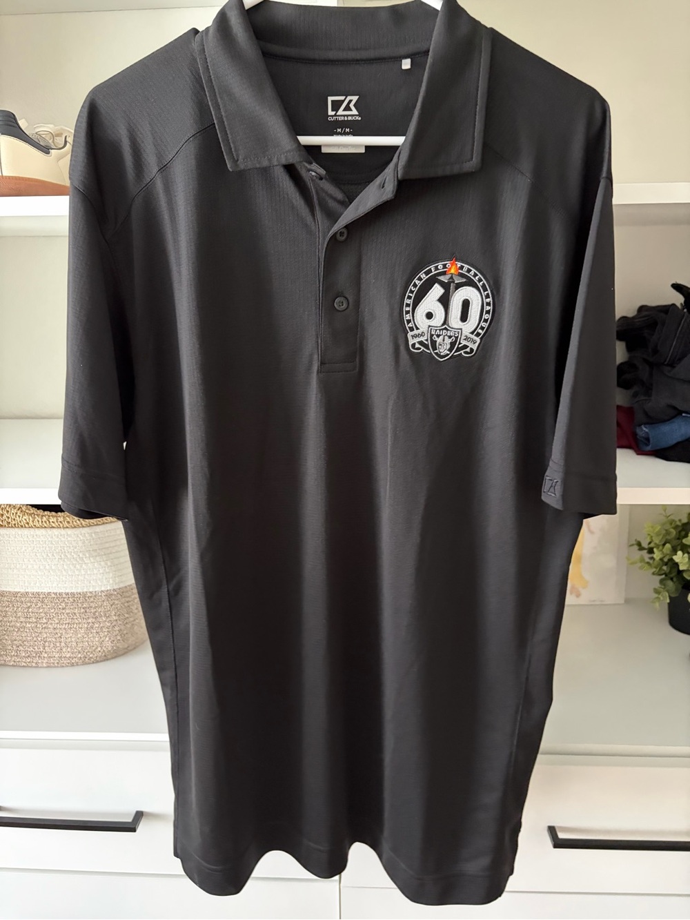 Cutter & Buck Black Men’s Golf Polo with 60th Anniversary Raiders Football Crest